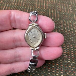 Vintage Helbros women's wristwatch. It features an oval, silver-tone  case.